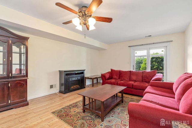 304 Woodbridge Commons Way, Iselin, NJ 08830 - living room featuring ceiling fan, light wood-type flooring, and a lit fireplace