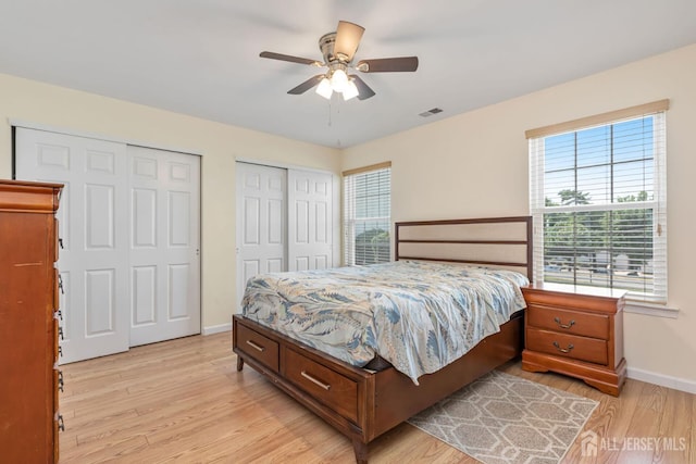 304 Woodbridge Commons Way, Iselin, NJ 08830 - bedroom featuring multiple closets, light wood-style floors, and ceiling fan