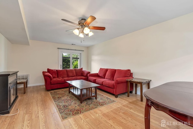 304 Woodbridge Commons Way, Iselin, NJ 08830 - living room featuring ceiling fan, light wood-style flooring, and a wood stove