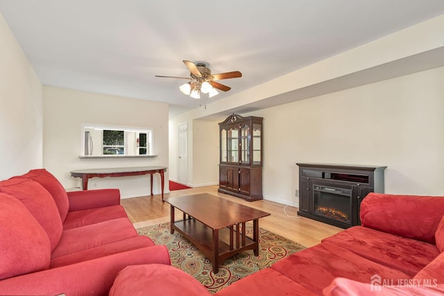 304 Woodbridge Commons Way, Iselin, NJ 08830 - living area featuring wood finished floors, a ceiling fan, and a glass covered fireplace