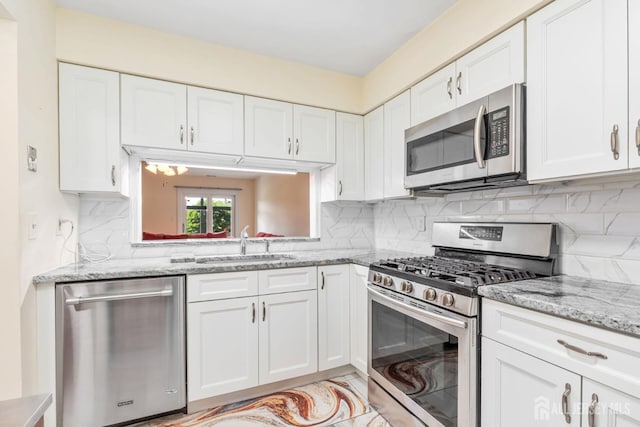 304 Woodbridge Commons Way, Iselin, NJ 08830 - kitchen with appliances with stainless steel finishes, white cabinets, tasteful backsplash, and light stone counters