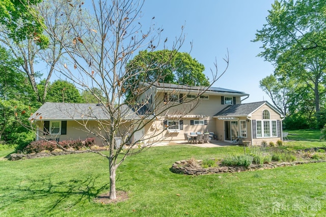 rear view of property with a patio area and a yard