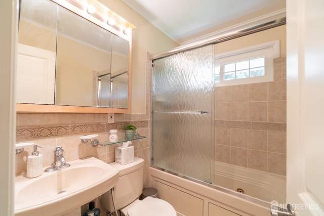 full bath featuring a sink, toilet, bath / shower combo with glass door, and crown molding