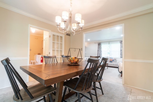 dining room featuring a chandelier, ornamental molding, and light colored carpet