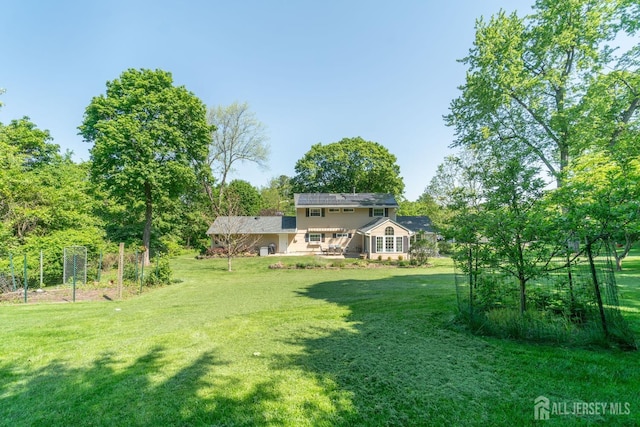 view of green lawn with a deck