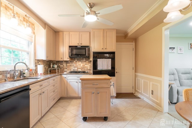 kitchen featuring black appliances, a sink, butcher block counters, ornamental molding, and backsplash