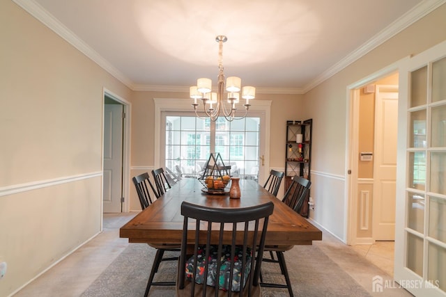 dining room featuring a chandelier and crown molding