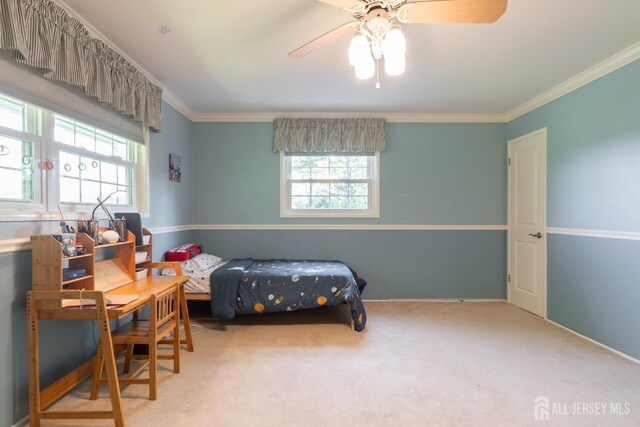 bedroom with multiple windows, carpet floors, crown molding, and ceiling fan