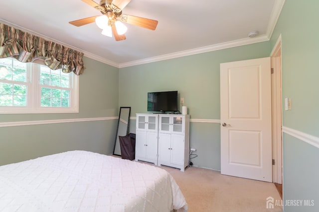 bedroom with light carpet, ornamental molding, and ceiling fan