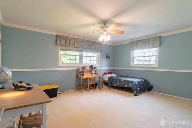 carpeted bedroom featuring crown molding, baseboards, and a ceiling fan