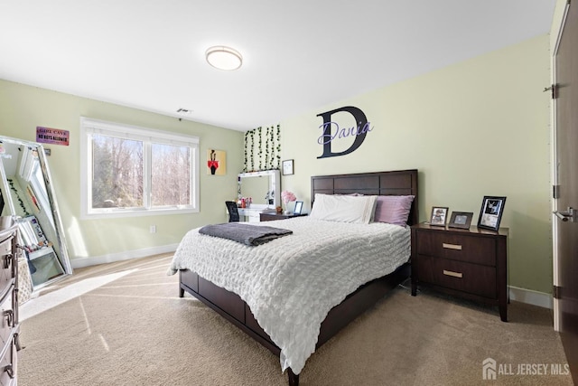 bedroom featuring baseboards, visible vents, and light colored carpet