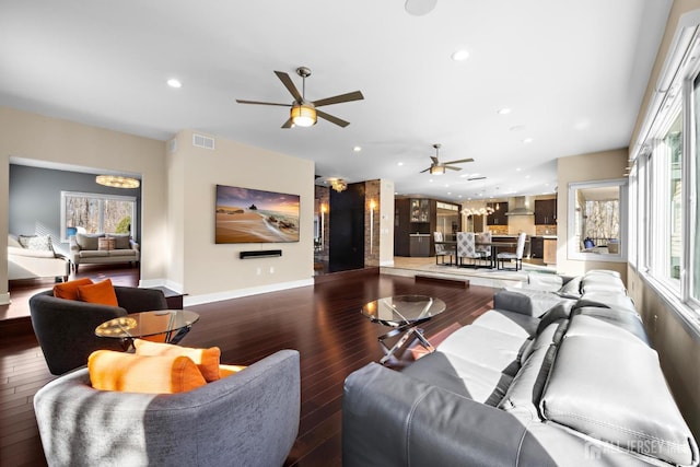 living room featuring baseboards, visible vents, ceiling fan, wood finished floors, and recessed lighting