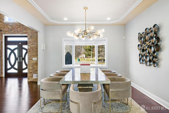 dining room with a chandelier, recessed lighting, dark wood-type flooring, baseboards, and ornamental molding