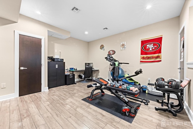 exercise room featuring recessed lighting, visible vents, baseboards, and wood finished floors