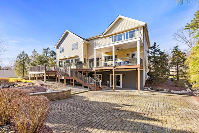 rear view of property with stairs, a patio area, a wooden deck, and a ceiling fan