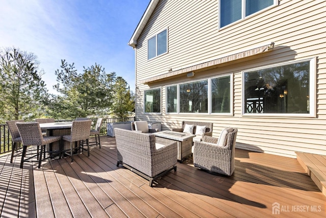 wooden terrace featuring outdoor dry bar and an outdoor hangout area