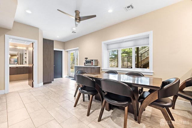 dining room with baseboards, a ceiling fan, visible vents, and recessed lighting