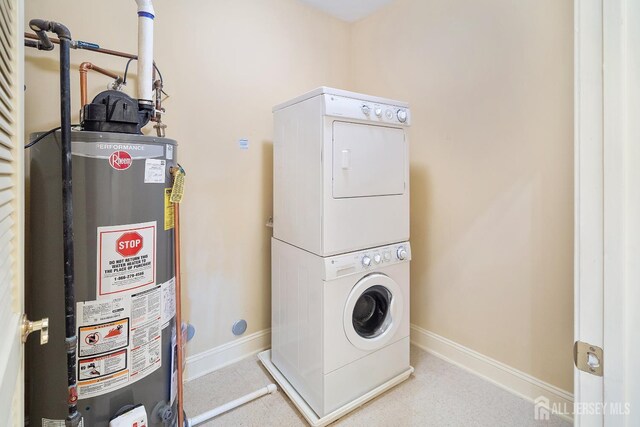 540 Cranbury Rd Unit 105, East Brunswick, NJ 08816 - laundry area with gas water heater, stacked washing machine and dryer, and baseboards
