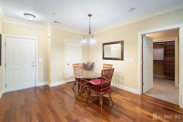 540 Cranbury Rd Unit 105, East Brunswick, NJ 08816 - dining space featuring baseboards, crown molding, and wood finished floors