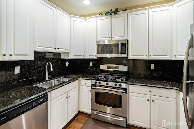 540 Cranbury Rd Unit 105, East Brunswick, NJ 08816 - kitchen with stainless steel appliances, a sink, white cabinets, and decorative backsplash