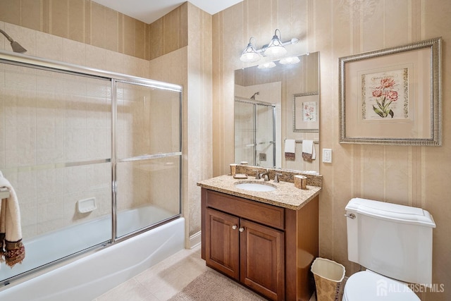 540 Cranbury Rd Unit 105, East Brunswick, NJ 08816 - bathroom with combined bath / shower with glass door, toilet, vanity, and tile patterned floors