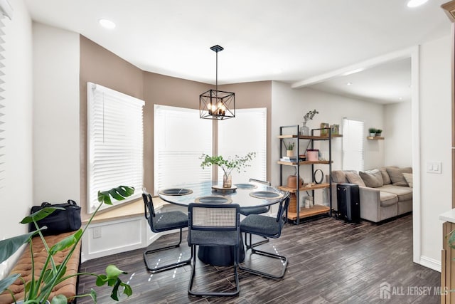dining room with a notable chandelier, dark wood-style floors, lofted ceiling, and recessed lighting