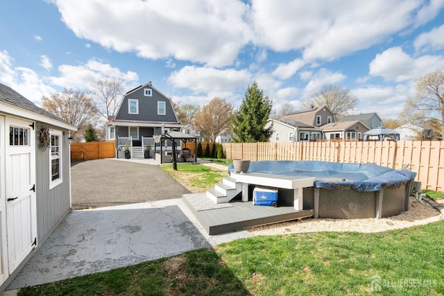 view of yard featuring a fenced in pool, a residential view, a patio area, a fenced backyard, and a deck