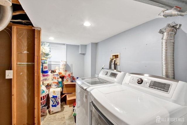 laundry room featuring recessed lighting, washing machine and dryer, and laundry area