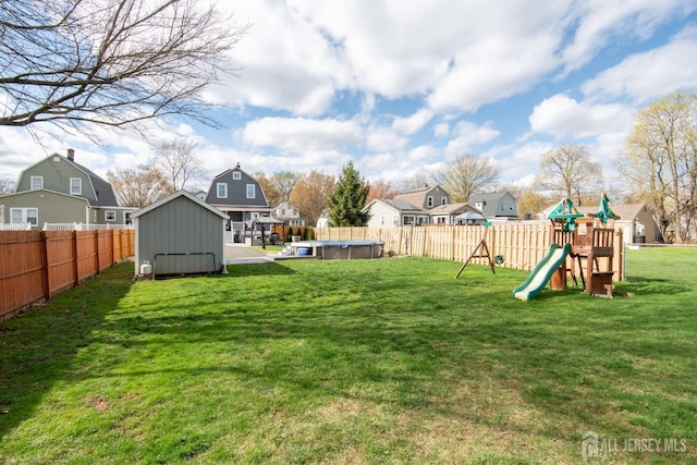 view of yard featuring a storage shed, an outdoor structure, a playground, a fenced in pool, and a residential view