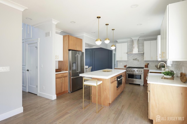 14 Thomasine St, Edison, NJ 08817 - kitchen with premium appliances, wall chimney exhaust hood, a kitchen island, decorative backsplash, and light countertops