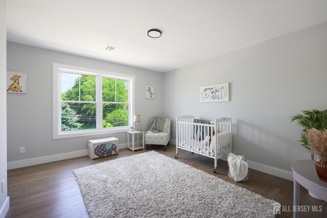 14 Thomasine St, Edison, NJ 08817 - bedroom with wood finished floors and a crib