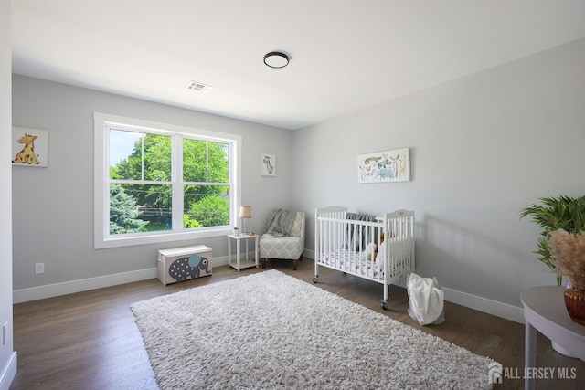 14 Thomasine St, Edison, NJ 08817 - bedroom featuring wood finished floors and a crib