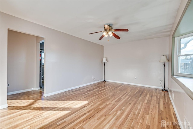 empty room with ceiling fan and light wood-type flooring