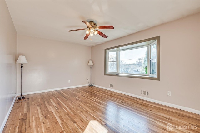 unfurnished room with ceiling fan and light hardwood / wood-style floors