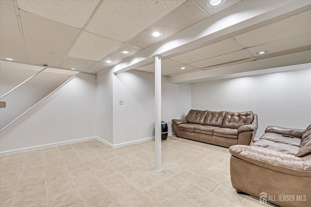 living room featuring a drop ceiling