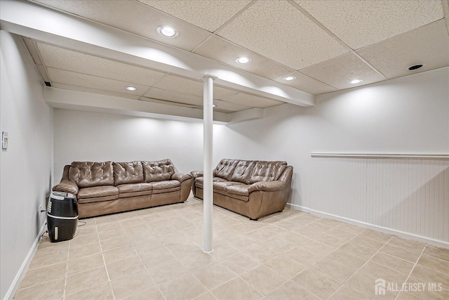 basement with a paneled ceiling