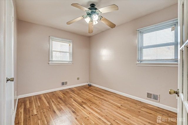 empty room with ceiling fan and light wood-type flooring