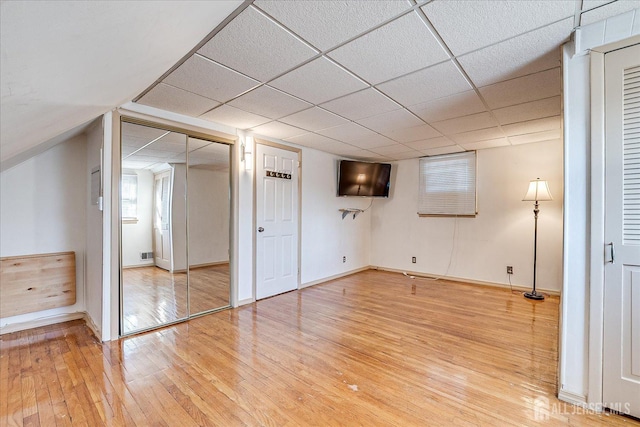 interior space featuring wood-type flooring and a paneled ceiling