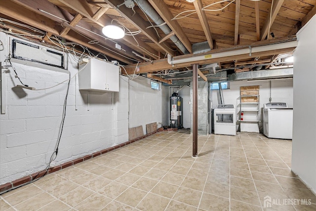 basement with gas water heater, light tile patterned floors, and independent washer and dryer