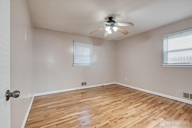 unfurnished room with ceiling fan and light wood-type flooring