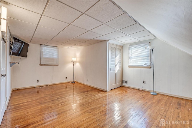 interior space with a drop ceiling and light wood-type flooring