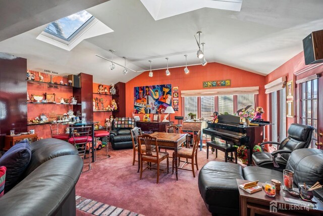 carpeted living room featuring lofted ceiling with skylight