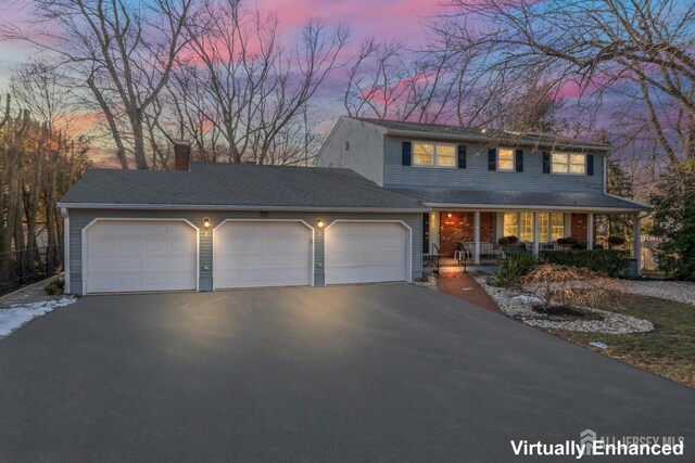 view of front of home with covered porch and a garage