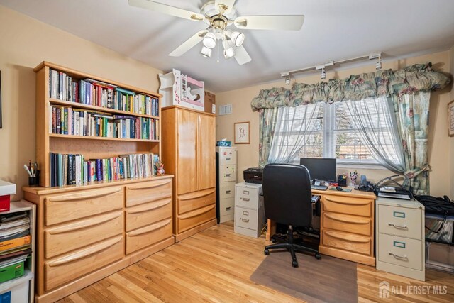 home office with ceiling fan and light hardwood / wood-style floors