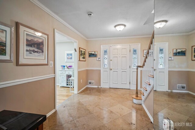 entrance foyer featuring crown molding