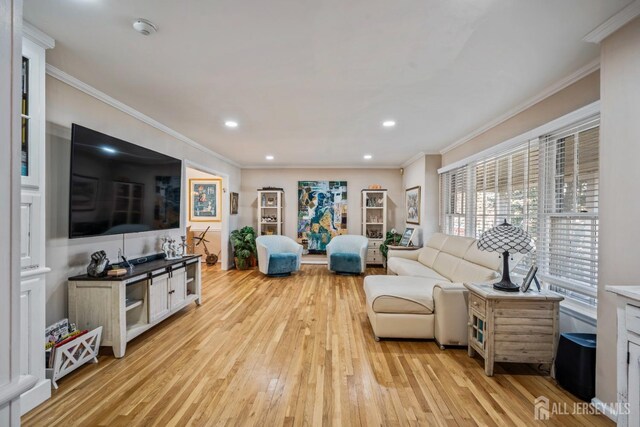 living room featuring crown molding and light wood-type flooring