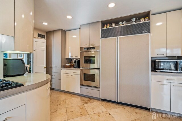 kitchen featuring appliances with stainless steel finishes and white cabinets