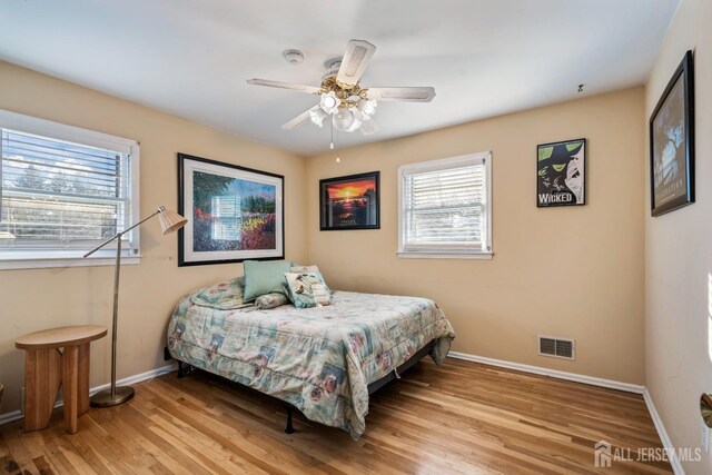 bedroom with ceiling fan and light hardwood / wood-style flooring