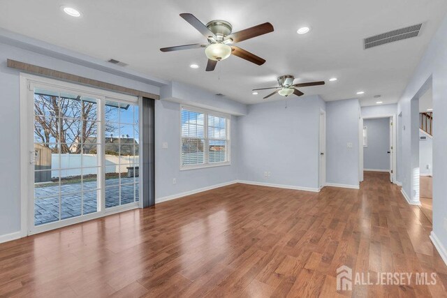 unfurnished living room featuring hardwood / wood-style floors and ceiling fan