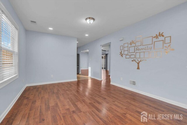 empty room with hardwood / wood-style floors